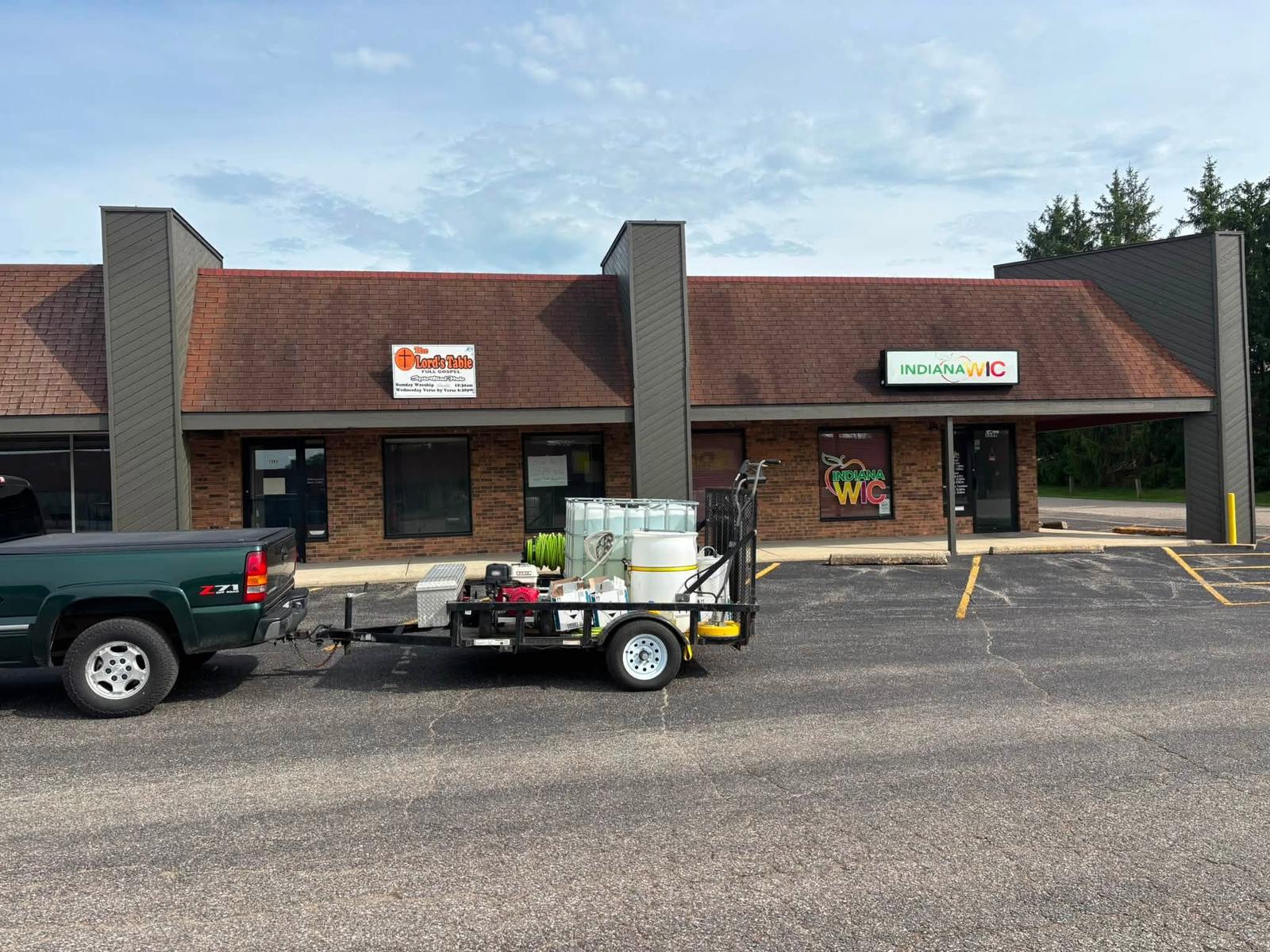 Truck and equipment trailer set up on site at the job