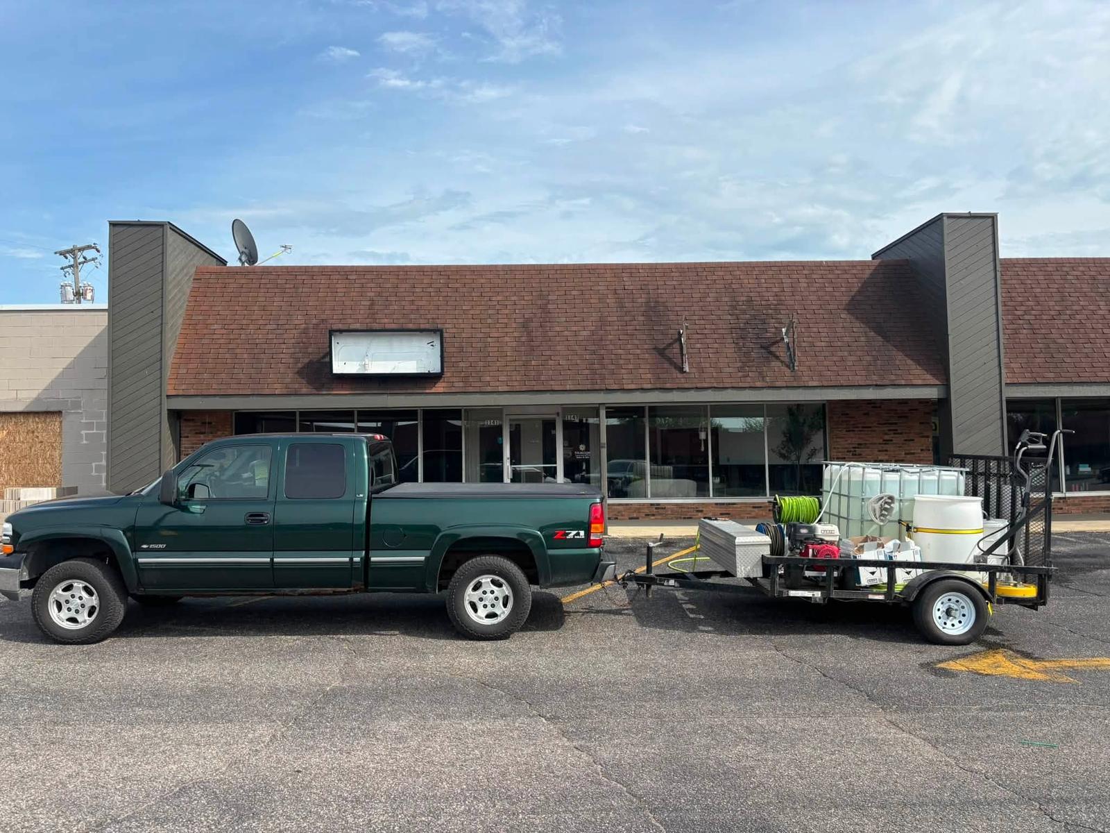 End unit of the strip center with heavy roof streaking before cleaning