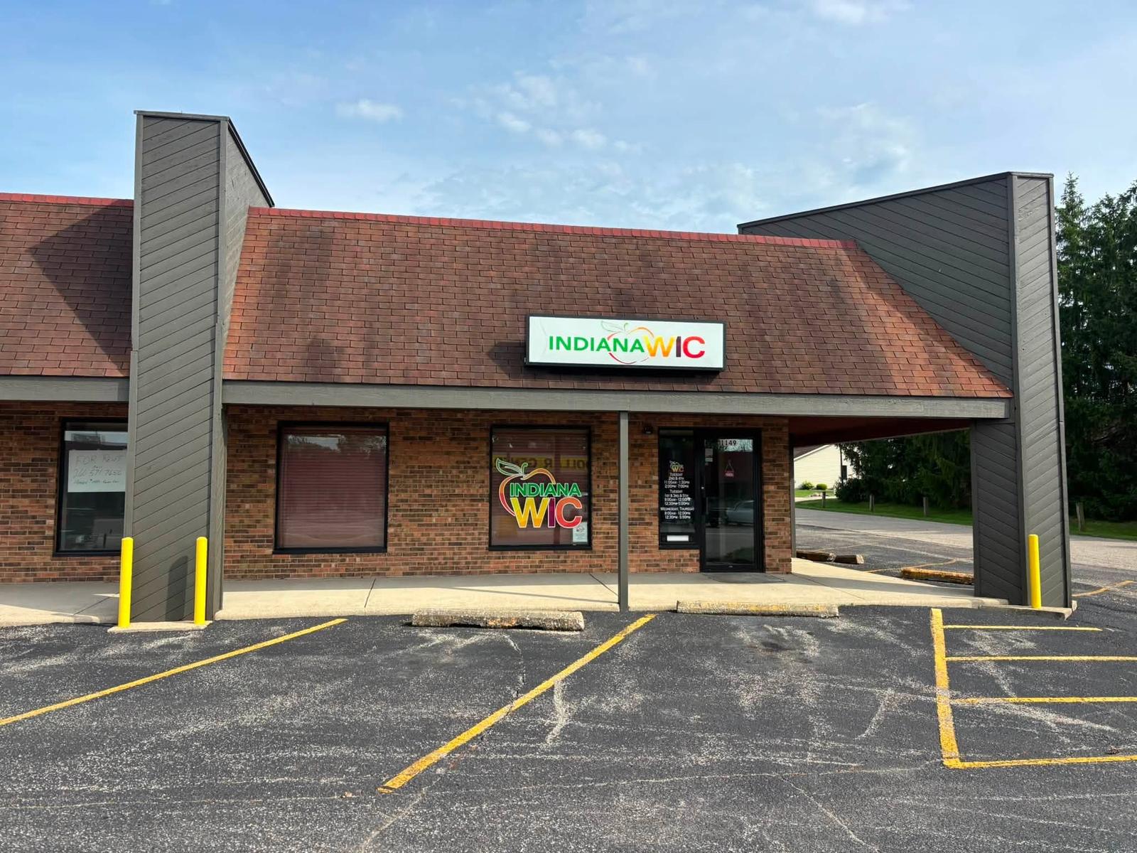 Storefront entrance with a dull algae stained roof before cleaning